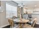 Elegant dining area with a round table, four chairs, and a view of the kitchen at 11255 E 25Th Ave, Aurora, CO 80010