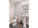 Clean powder room with pedestal sink, toilet and stylish accents at 11255 E 25Th Ave, Aurora, CO 80010
