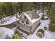 A-frame home with snowy surroundings and a deck at 30162 Pine Crest Dr, Evergreen, CO 80439