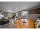 Dining area with a round table and chairs, offering views and living room access at 30162 Pine Crest Dr, Evergreen, CO 80439