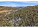 Aerial view of property and surrounding mountain landscape at 30162 Pine Crest Dr, Evergreen, CO 80439
