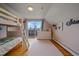 Bedroom with bunk beds, dresser, and deck access at 30162 Pine Crest Dr, Evergreen, CO 80439