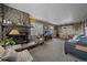 Open living area featuring a stone fireplace and dining area at 30162 Pine Crest Dr, Evergreen, CO 80439