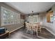 Bright dining room features a table with four chairs, a fish tank, and views of trees at 30162 Pine Crest Dr, Evergreen, CO 80439