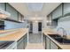 Kitchen with gray cabinets, wood countertops, and view to dining area at 1777 S Pitkin St # B, Aurora, CO 80017