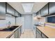Galley kitchen with gray cabinets and wood countertops at 1777 S Pitkin St # B, Aurora, CO 80017