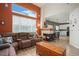 Spacious living room with fireplace and view into kitchen at 19427 E Bellisario Creek Dr, Parker, CO 80134