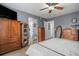 Main bedroom with wood furniture and access to bathroom at 19427 E Bellisario Creek Dr, Parker, CO 80134