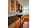 Kitchen with wood cabinets, granite counters, and gas range at 15626 Greenstone Cir, Parker, CO 80134