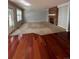Spacious living room featuring hardwood and carpet flooring, a brick fireplace, and sliding glass doors at 15626 Greenstone Cir, Parker, CO 80134