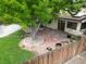 Elevated view of backyard oasis with patio, large tree, and rock landscaping at 1325 S Vrain St, Denver, CO 80219