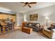 Open concept kitchen and living area with wood cabinets and a dining table at 22960 E Roxbury Dr # G, Aurora, CO 80016