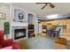 Open concept living space with fireplace and kitchen featuring wood cabinets at 22960 E Roxbury Dr # G, Aurora, CO 80016