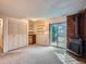 Finished basement recreation room with wood-burning stove, built-in shelving, and backyard access at 1115 Delphi Dr, Lafayette, CO 80026