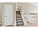 Clean carpeted staircase with white railings leading to the upper level at 12327 Utica St, Broomfield, CO 80020