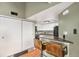Small kitchen with granite countertops and black appliances at 8701 Huron St # 1-210, Thornton, CO 80260