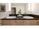 Double vanity bathroom with dark countertop and large mirror at 1560 Blake St # 810, Denver, CO 80202