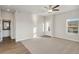 Living room with entryway, neutral carpeting, and sliding glass doors at 2992 Oxley St, Strasburg, CO 80136