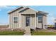 Modern farmhouse style home with gray siding at 2992 Oxley St, Strasburg, CO 80136
