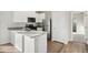 Modern kitchen with white cabinets and stainless steel appliances at 2992 Oxley St, Strasburg, CO 80136
