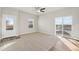 Spacious living room with sliding glass doors and neutral decor at 2992 Oxley St, Strasburg, CO 80136