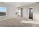 Bright bedroom featuring carpet flooring and a large closet at 2992 Oxley St, Strasburg, CO 80136