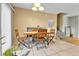 Bright dining area with a wooden table and chairs, adjacent to a staircase at 17769 E Iowa Dr, Aurora, CO 80017