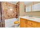 Main bathroom with bathtub, toilet, and wooden vanity at 17769 E Iowa Dr, Aurora, CO 80017