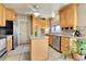 Kitchen with oak cabinets, island, and stainless steel appliances at 17769 E Iowa Dr, Aurora, CO 80017