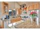 Modern kitchen with stainless steel appliances and granite countertops at 333 Buena Vista Ave, Palmer Lake, CO 80133