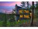 Modern home with mountain views and large deck at dusk at 141 Shekel Ln, Breckenridge, CO 80424