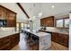 Open concept kitchen boasts expansive island, stainless steel appliances, and rich wood cabinets at 141 Shekel Ln, Breckenridge, CO 80424