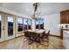 Bright dining area with large windows, rustic wood table, and stunning mountain views at 141 Shekel Ln, Breckenridge, CO 80424