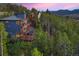 Aerial view of a luxury mountain home nestled in a wooded area at 141 Shekel Ln, Breckenridge, CO 80424