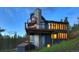 Luxury home with stone fireplace and deck at dusk at 141 Shekel Ln, Breckenridge, CO 80424