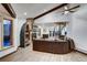 Open living room with a stone fireplace, leather sofa, and mountain views at 141 Shekel Ln, Breckenridge, CO 80424