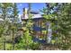 Modern mountain home nestled in trees, showcasing expansive windows and private deck at 141 Shekel Ln, Breckenridge, CO 80424