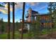 Modern mountain home with a deck and mountain views in the background at 141 Shekel Ln, Breckenridge, CO 80424