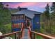 Modern home with walkway and mountain views at dusk at 141 Shekel Ln, Breckenridge, CO 80424