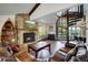 Cozy living room with stone fireplace, leather sofas, and a spiral staircase at 141 Shekel Ln, Breckenridge, CO 80424