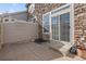 Private backyard with stone wall and sliding glass door access at 7353 Norfolk Pl, Castle Pines, CO 80108