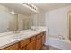 Bathroom with double vanity, shower, and bathtub at 7353 Norfolk Pl, Castle Pines, CO 80108