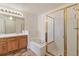 Bathroom with double vanity, shower, and bathtub at 7353 Norfolk Pl, Castle Pines, CO 80108