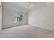 Spacious bedroom with carpeted floor and large window at 7353 Norfolk Pl, Castle Pines, CO 80108