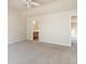Spacious carpeted bedroom with ceiling fan and access to a private bathroom at 7353 Norfolk Pl, Castle Pines, CO 80108