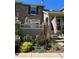 Stone and siding townhouse exterior with landscaping and American flag at 7353 Norfolk Pl, Castle Pines, CO 80108