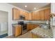 Modern kitchen featuring stainless steel appliances and wood cabinetry at 7353 Norfolk Pl, Castle Pines, CO 80108