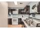 White appliances and dark wood cabinets in this galley-style kitchen at 5550 W 80Th Pl # 15, Arvada, CO 80003