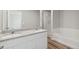 Bathroom with granite countertop, double sinks, and tub at 7203 Dolores Ave, Frederick, CO 80530