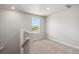 Open loft area with carpet and large window at 7203 Dolores Ave, Frederick, CO 80530